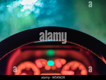 Street lights bokeh and Blurry Raindrops on the windshield of a car for background usage. Stock Photo