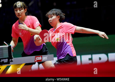 Zhu Yuling of China returns a shot to Belma Busatlic and Emina Hadziahmetovic of Bosnia and Herzegovina in their first round match of Women's Doubles Stock Photo