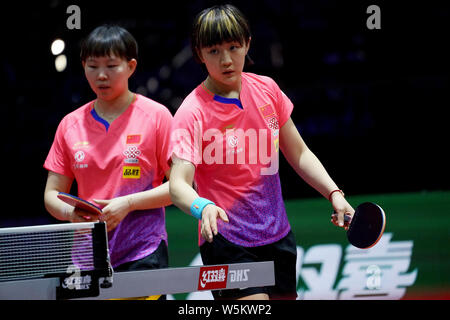 Chen Meng and Zhu Yuling of China react as they compete against Belma Busatlic and Emina Hadziahmetovic of Bosnia and Herzegovina in their first round Stock Photo