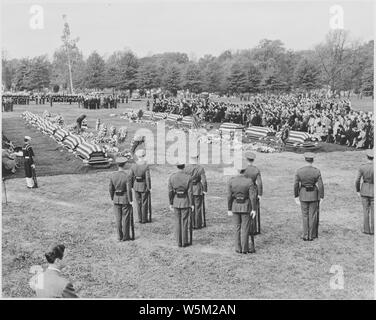 Distance view of President Truman attending the burial of twenty soldiers at Arlington National Cemetery. These twenty were the first war dead, now returned to be buried in their native land. Stock Photo