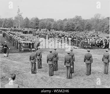 Distance view of President Truman attending the burial of twenty soldiers at the Arlington National Cemetery. These twenty were the first war dead, now returned to be buried in their native land. Stock Photo