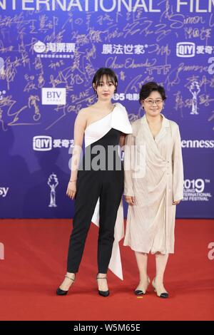 Chinese actress Bai Baihe, left, and film and television director and producer Li Shaohong, pose as they arrive on the red carpet for the opening cere Stock Photo