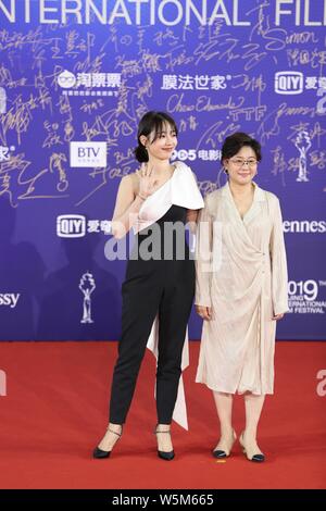 Chinese actress Bai Baihe, left, and film and television director and producer Li Shaohong, pose as they arrive on the red carpet for the opening cere Stock Photo