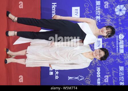 Chinese actress Bai Baihe, left, and film and television director and producer Li Shaohong, pose as they arrive on the red carpet for the opening cere Stock Photo