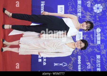 Chinese actress Bai Baihe, left, and film and television director and producer Li Shaohong, pose as they arrive on the red carpet for the opening cere Stock Photo