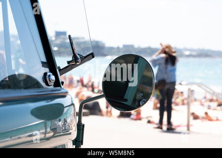An Australian beach scene with a Volkswagen Combi in the foreground Stock Photo