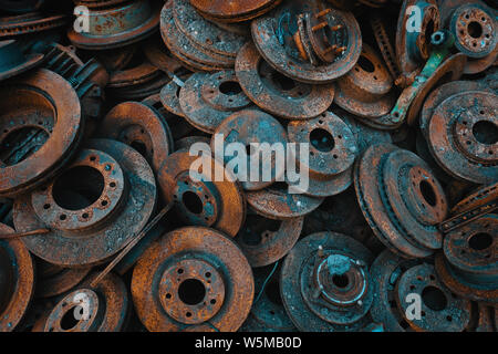 A large pile of rusted, worn brake disks Stock Photo