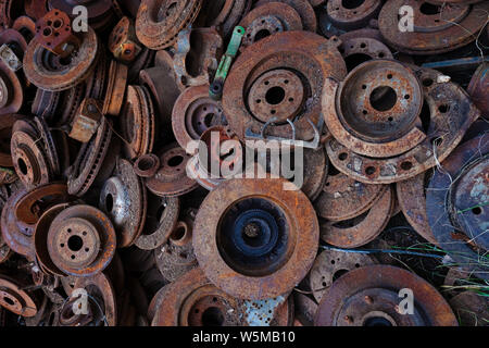 A large pile of rusted, worn brake disks Stock Photo