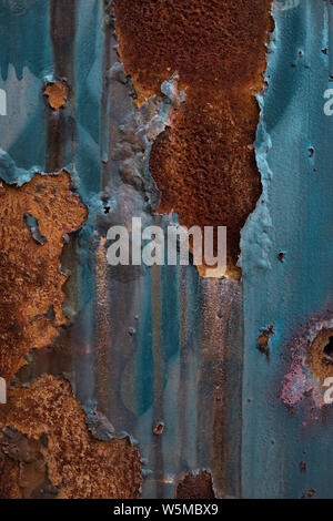 Textured industrial grunge background - peeling, cracked, corroded paint and rust on a wall. Stock Photo