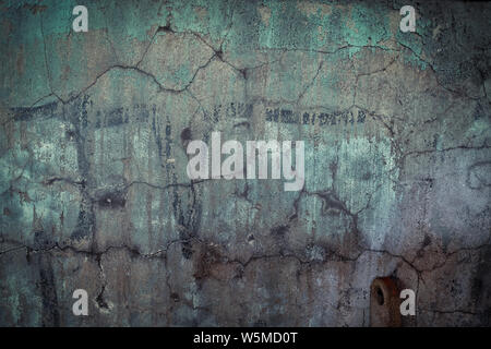 Textured industrial grunge background - peeling, cracked, corroded paint and rust on a wall. Stock Photo