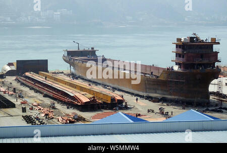 --FILE--Chinese workers manufacture a cargo ship at a factory in Yichang city, central China's Hubei province, 3 March 2019.   Orders for China's ship Stock Photo