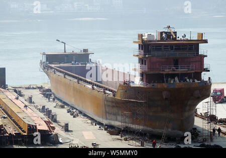 --FILE--Chinese workers manufacture a cargo ship at a factory in Yichang city, central China's Hubei province, 3 March 2019.   Orders for China's ship Stock Photo