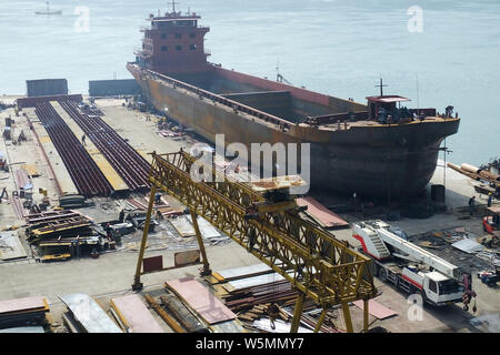 --FILE--Chinese workers manufacture a cargo ship at a factory in Yichang city, central China's Hubei province, 3 March 2019.   Orders for China's ship Stock Photo