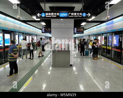 Passengers wait for their subway trains of Zhujiang New Town