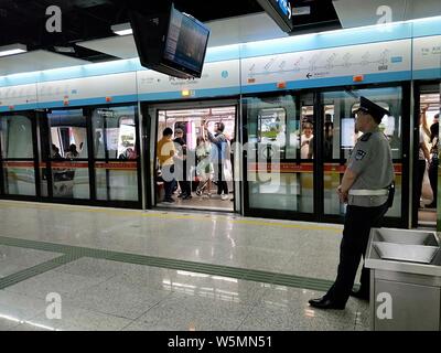 Passengers wait for their subway trains of Zhujiang New Town