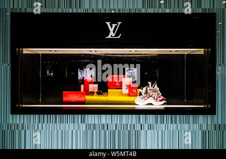 FILE--View of a shopwindow of Louis Vuitton (LV) in Wuhan city, central  China's Hubei province, 18 March 2019. LVMH shares hit a record high on  Thursday and buoyed those of rivals after