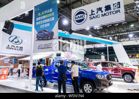 --FILE--People visit the stand of Shanghai Automotive Industry Corporation (SAIC) during the Shanghai Pudong International Automotive Exhibition 2018 Stock Photo