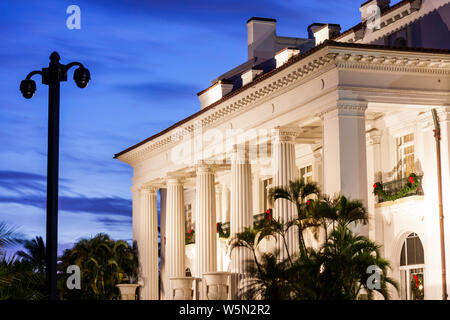 Palm Beach Florida,Flagler Mansion Museum,historic landmark,Guilded Age,building,outside exterior front,entrance,lighted,dusk,evening,column,Beaux Art Stock Photo