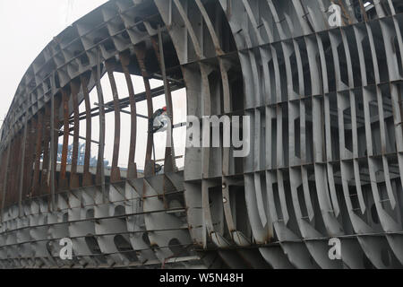 --FILE--Chinese workers manufacture a cargo ship at a factory in Guanyun county, Lianyungang city, east China's Jiangsu province, 12 February 2019. Stock Photo