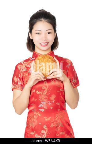 Beautiful Chinese woman wearing a Cheongsam or Chipao holding a Moon Cake the traditional food of the Chinese holiday of Mid Autumn Festival isolated Stock Photo