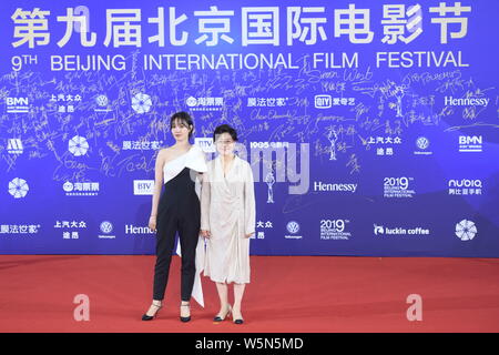 Chinese actress Bai Baihe, left, and film and television director and producer Li Shaohong, pose as they arrive on the red carpet for the opening cere Stock Photo