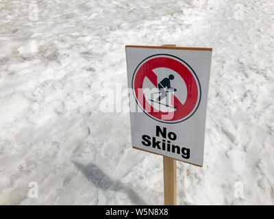 No skiing sign in winter in snowy conditions, in snowy mountains. Stock Photo