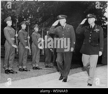 Gen. George C. Marshall, U. S. Army Chief of Staff, and Gen. Henry Hap Arnold, Commanding General, U. S. Army Air Forces, arrive at the residence of Prime Minister Winston Churchill for a dinner given by the British Prime Minister for President Truman and Soviet leader Josef Stalin during the Potsdam Conference. The two generals return the salute of the Guard of Honor formed by a detachment of Scots Guards of the British Brigade of Foot Guards Stock Photo