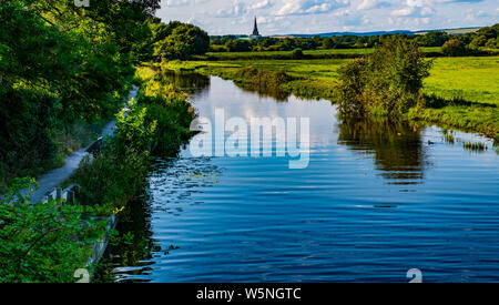 Chichester Cathedral from Hunston Bridge on the beautiful canal in West Sussex, England. The scene was painted by John Constable. Stock Photo