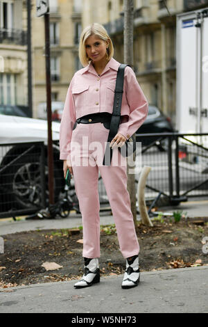 A trendy woman poses for street snaps during the Paris Fashion Week Womenswear Fall/Winter 2019/2020 street snap in Paris, France, 1 March 2019. Stock Photo