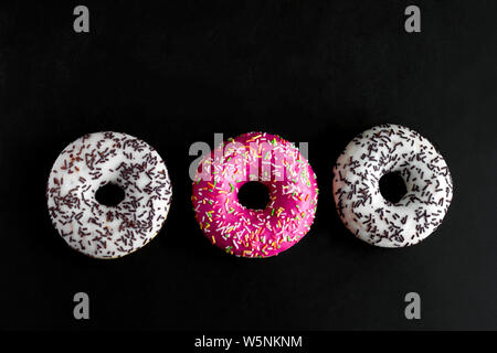 top view white and pink doughnuts on a black background Stock Photo