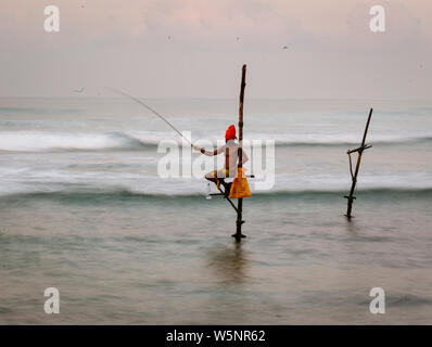 Galle, Sri Lanka - 2019-04-01 - Stilt Fishermen of Sri Lanka Spend All Day on Small Platforms to Catch Fish for Dinner. Stock Photo