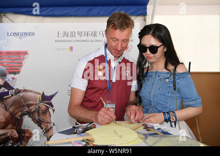 Dutch equestrian Jur Vrieling signs autographs for fans during the Shanghai Grand Prix of the 2019 Shanghai Longines Global Champions Tour in Shanghai Stock Photo