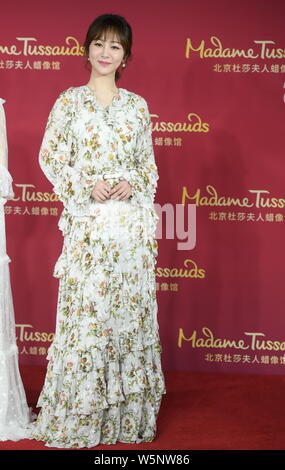 Chinese actress Andy Yang or Yang Zi poses during an unveiling ceremony for the wax figure of her at the Madame Tussauds museum in Beijing, China, 28 Stock Photo