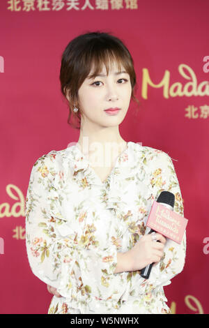 Chinese actress Andy Yang or Yang Zi poses during an unveiling ceremony for the wax figure of her at the Madame Tussauds museum in Beijing, China, 28 Stock Photo