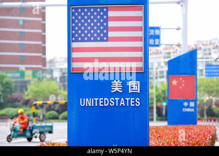 --FILE--Signboards showing the flag of the United States and Chinese National Flag are seen on a street in Qingdao city, east China's Shandong provinc Stock Photo