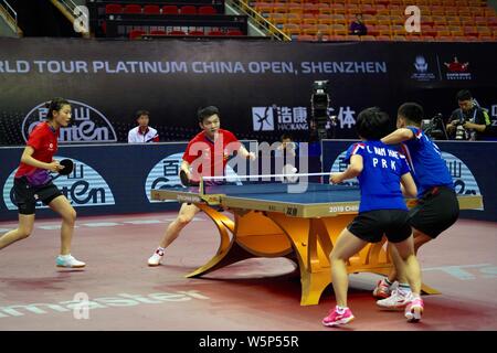 Fan Zhendong and Ding Ning of China return a shot to An Ji Song and Kim ...