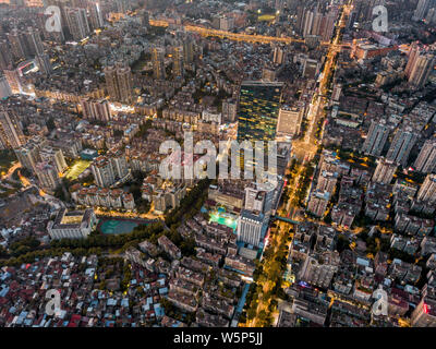 --FILE--An aerial night view of clusters of buildings and houses in Guangzhou city, south China's Guangdong province, 19 October 2017. Stock Photo