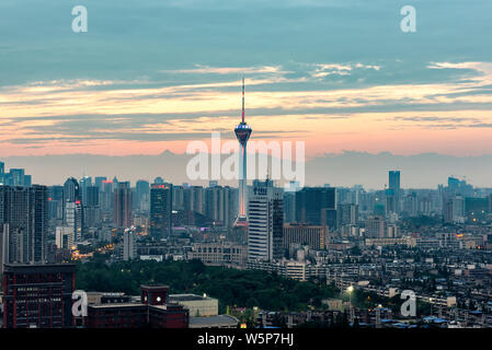Chengdu, Sichuan Province, China - July 25, 2019: Sichuan TV tower and skyline at dusk with the highest peak of Mount Siguniang background. Stock Photo