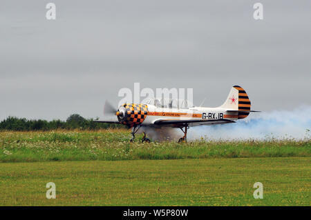 Yak-52 taking off Stock Photo