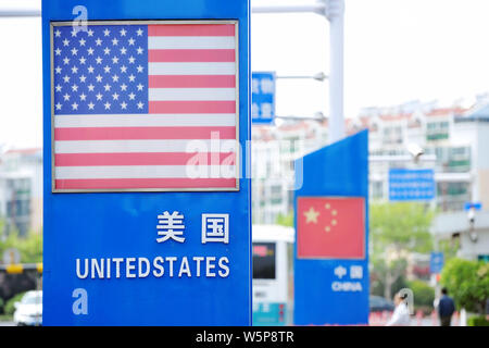 --FILE--Signboards showing the flag of the United States and Chinese National Flag are seen on a street in Qingdao city, east China's Shandong provinc Stock Photo