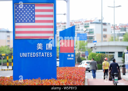 --FILE--Signboards showing the flag of the United States and Chinese National Flag are seen on a street in Qingdao city, east China's Shandong provinc Stock Photo