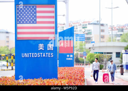 --FILE--Signboards showing the flag of the United States and Chinese National Flag are seen on a street in Qingdao city, east China's Shandong provinc Stock Photo