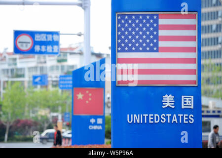 --FILE--Signboards showing the flag of the United States and Chinese National Flag are seen on a street in Qingdao city, east China's Shandong provinc Stock Photo