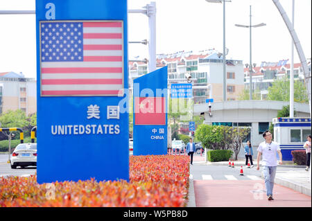 --FILE--Signboards showing the flag of the United States and Chinese National Flag are seen on a street in Qingdao city, east China's Shandong provinc Stock Photo