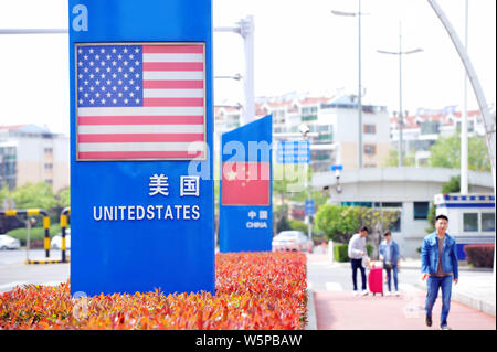 --FILE--Signboards showing the flag of the United States and Chinese National Flag are seen on a street in Qingdao city, east China's Shandong provinc Stock Photo