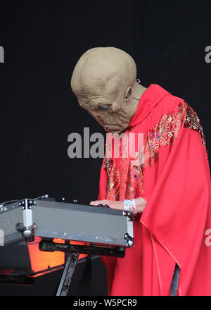 Lulworth, UK. 28th July, 2019. Goo, keyboard player with British band Henge winners of best live act at the Independent Festival Awards, performing live on stage in space alien clothing at UK family music and arts festival Camp Bestival in Lulworth, Dorset. Credit: SOPA Images Limited/Alamy Live News Stock Photo