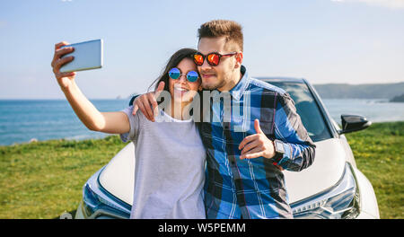 Young couple doing a selfie on the car Stock Photo