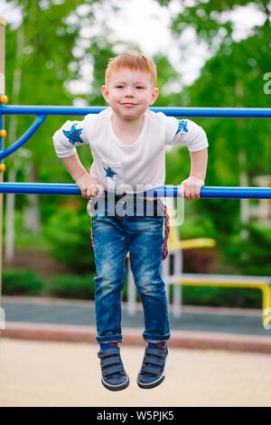 Little boy playing on the playground in summer time Stock Photo