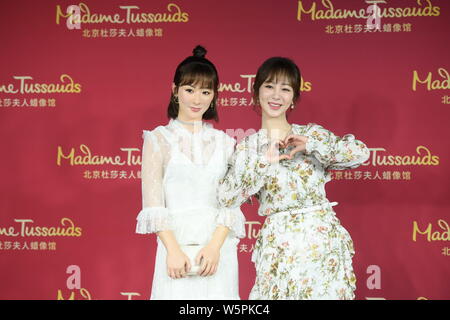 Chinese actress Andy Yang or Yang Zi poses with the wax figure of her during an unveiling ceremony at the Madame Tussauds museum in Beijing, China, 28 Stock Photo