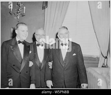 L to R: Unidentified man, President Truman, and Vice President Alben Barkley at the dinner in their honor at the Mayflower Hotel in Washington, D. C. Stock Photo